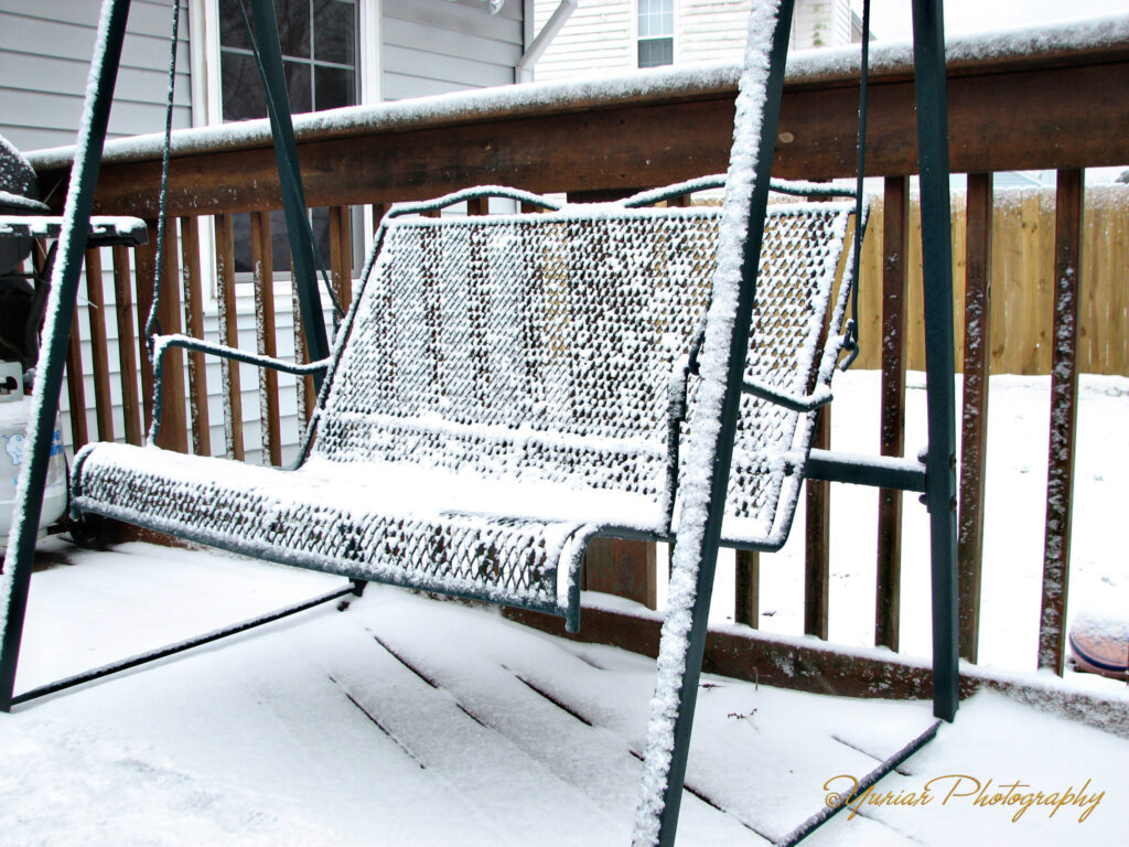 Snow covered Porch Swing